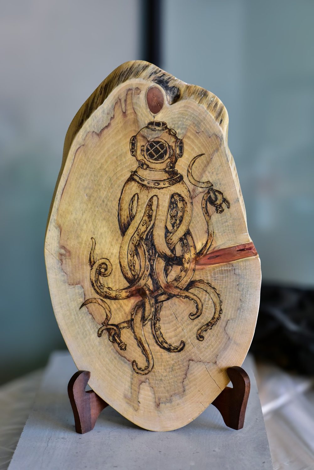 Distorted Reality — an octopus wearing a vintage brass diving helmet, tentacles curling across a rugged live-edge slab